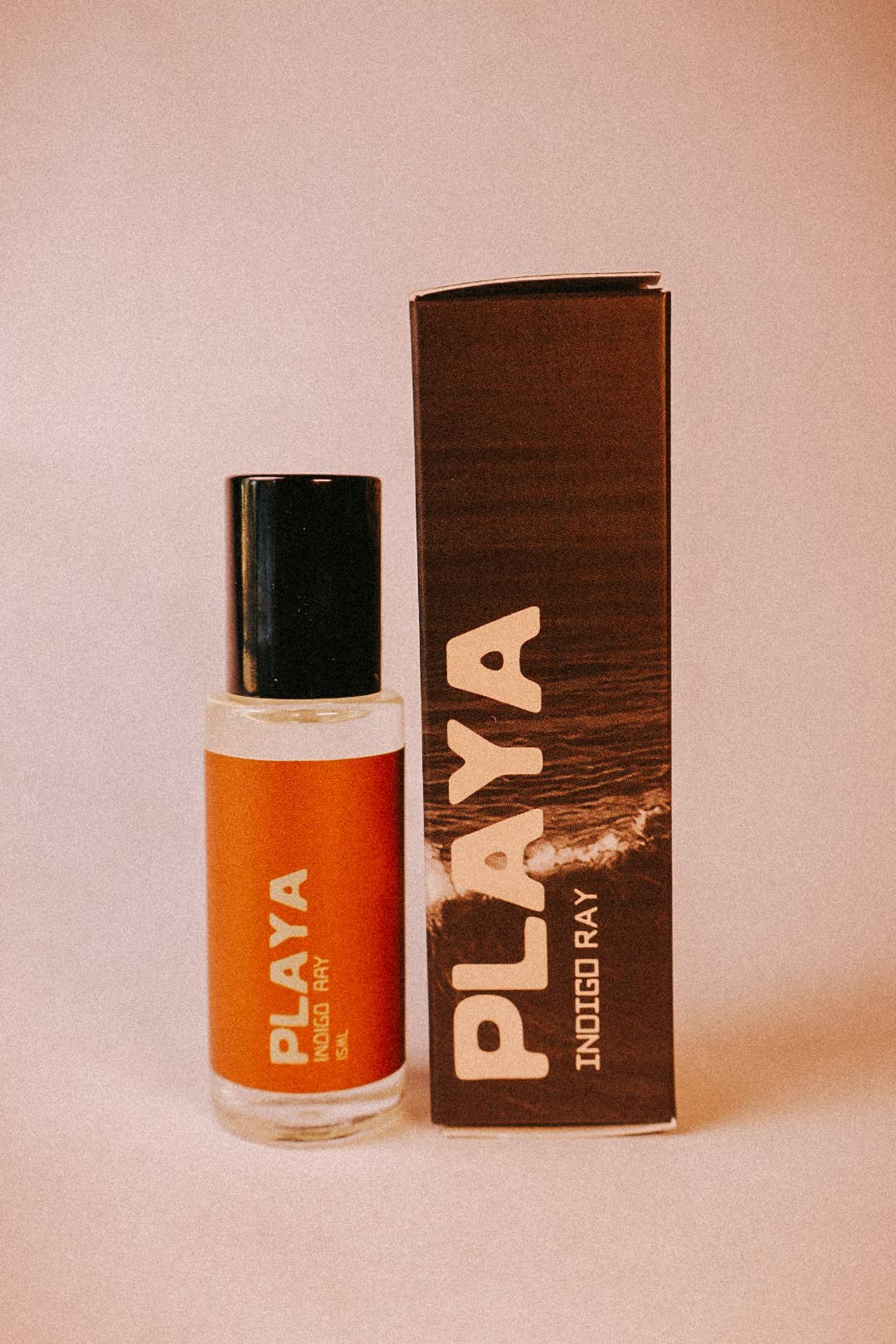 Playa perfume bottle and packaging on a beige background