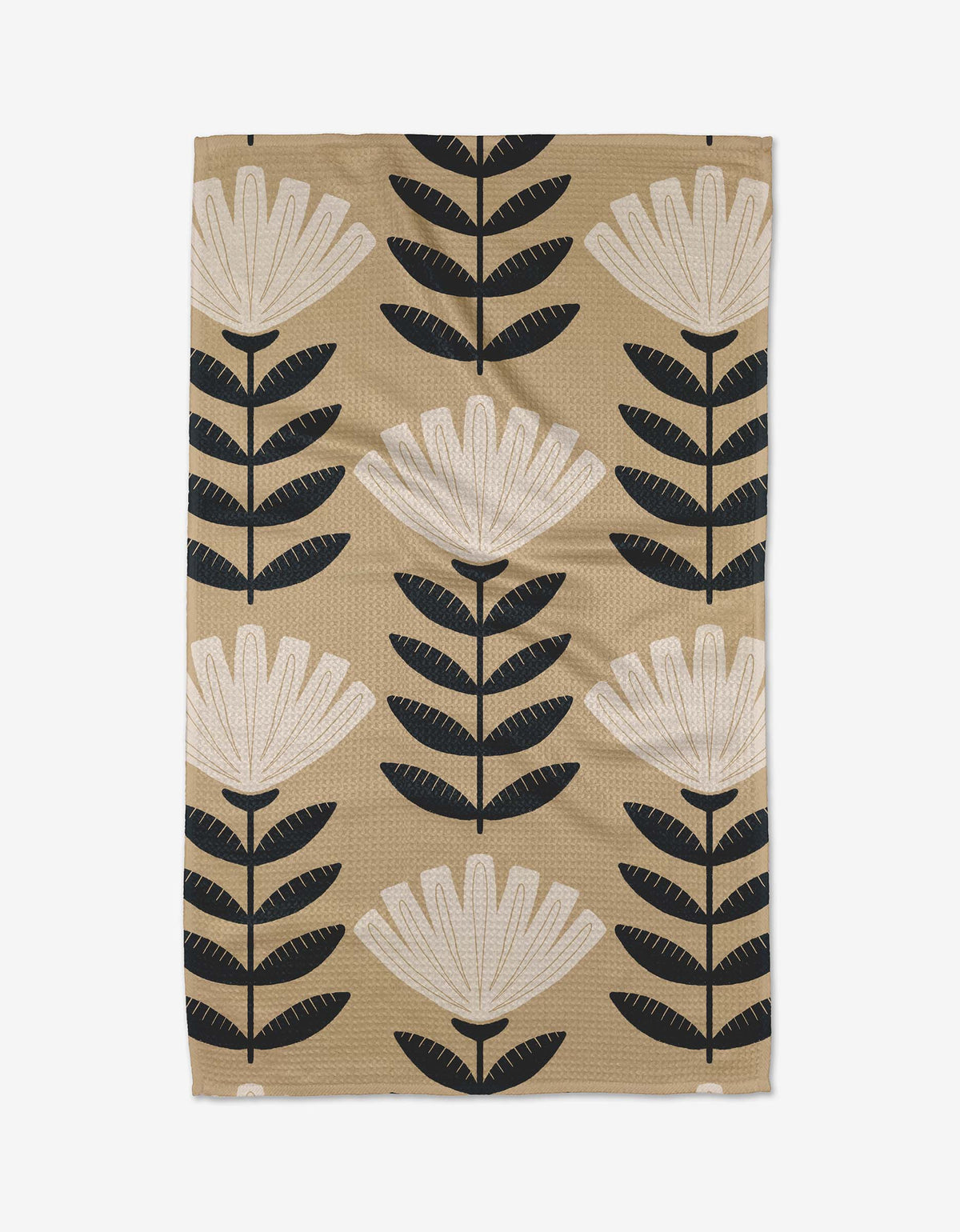 Floral patterned towel with black and white flowers on a beige background