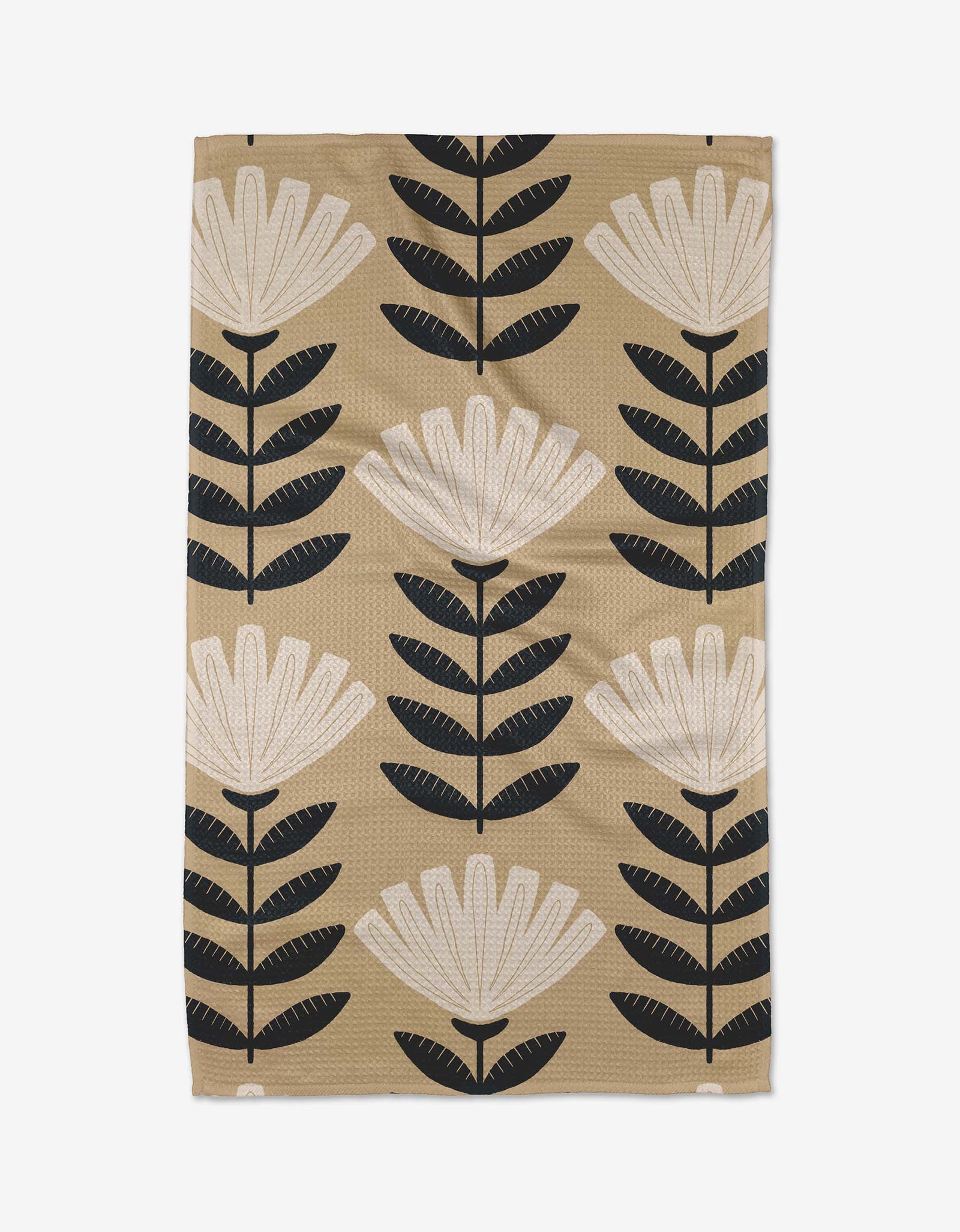 Floral patterned towel with black and white flowers on a beige background