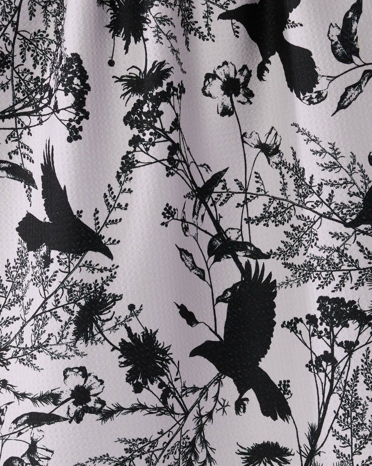 Spooky crow and fall foliage printed on fabric.