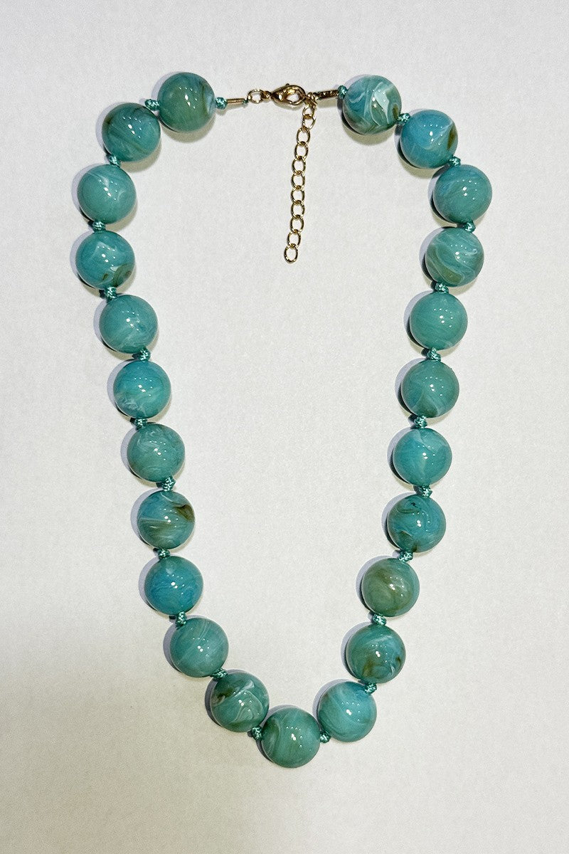 Turquoise - lake blue beaded necklace on a white background