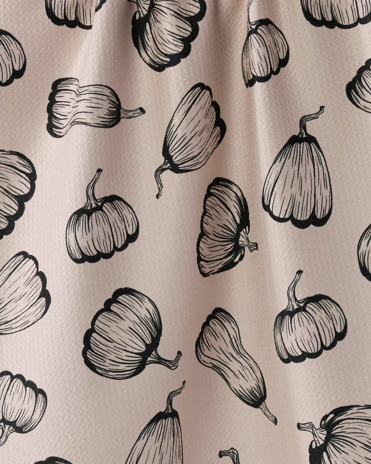 Pattern of black pumpkins on a beige background