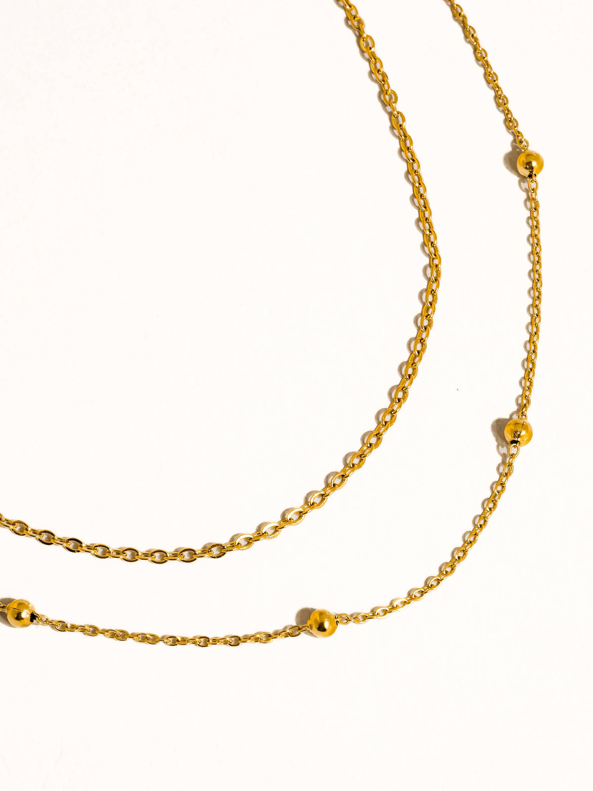 Gold anklet on a white background