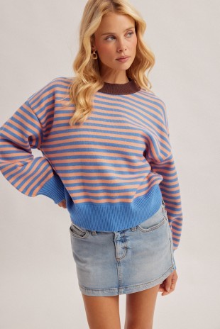 Blonde women wearing a bluepeach stripe sweater pullover and a denim skirt.