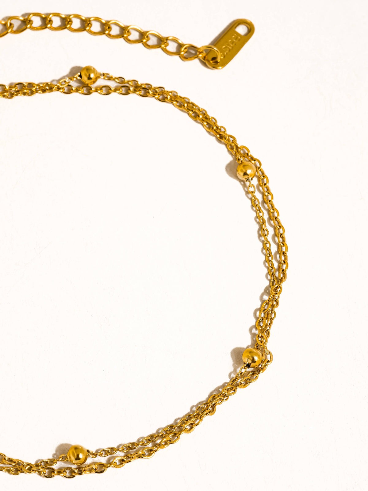 Gold anklet on a white background