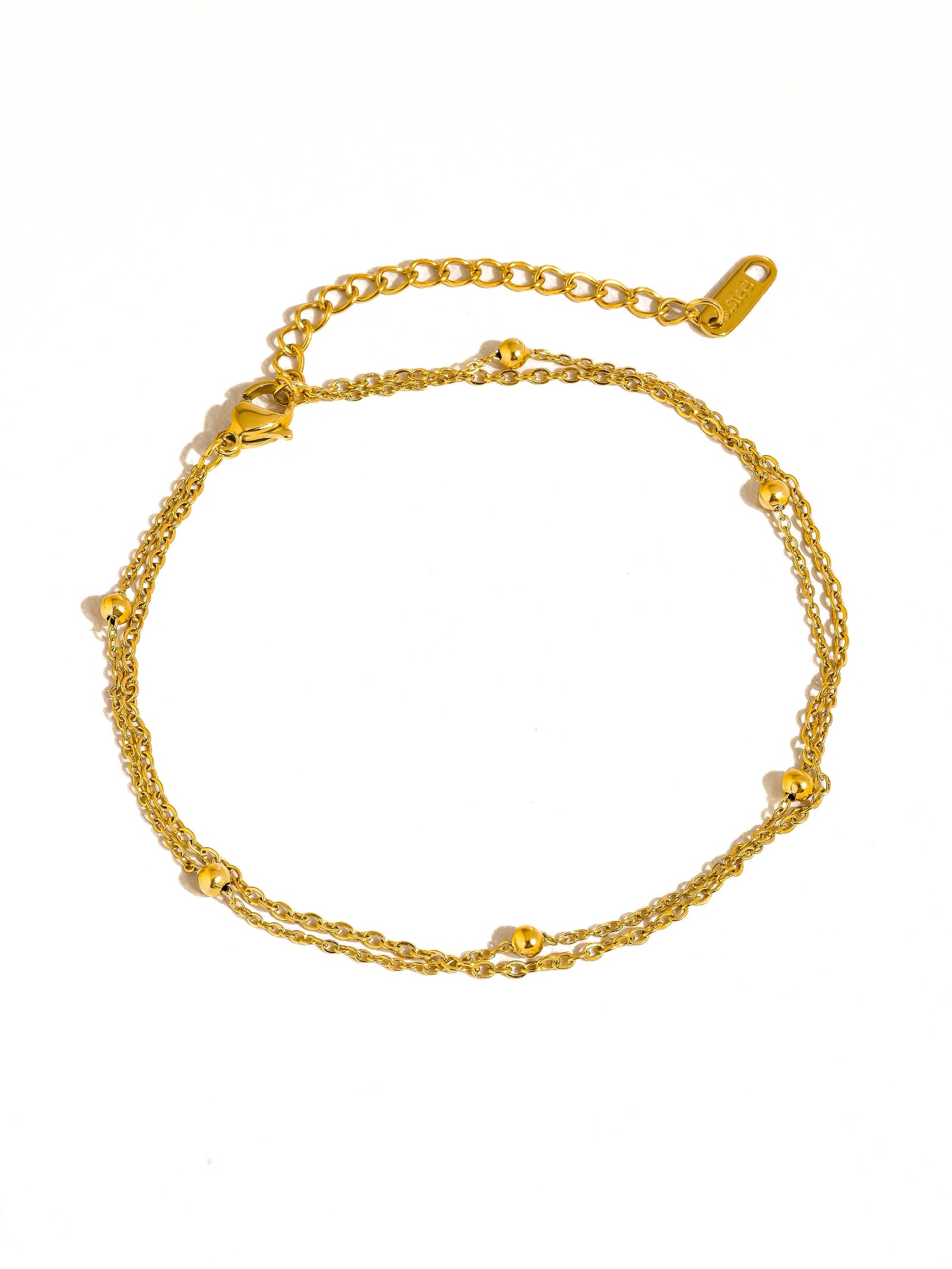 Gold anklet on a white background
