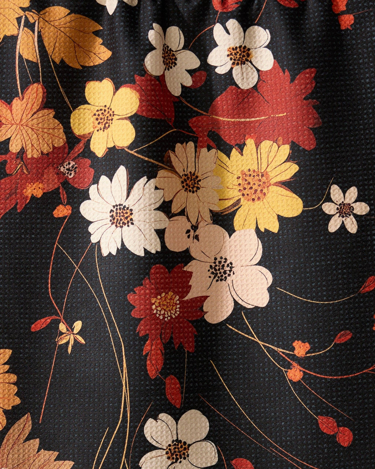 Floral pattern with red, yellow, and white flowers on a black background